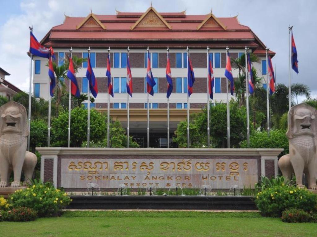 a building with flags in front of a building at Sokhalay Angkor Residence and Spa in Siem Reap