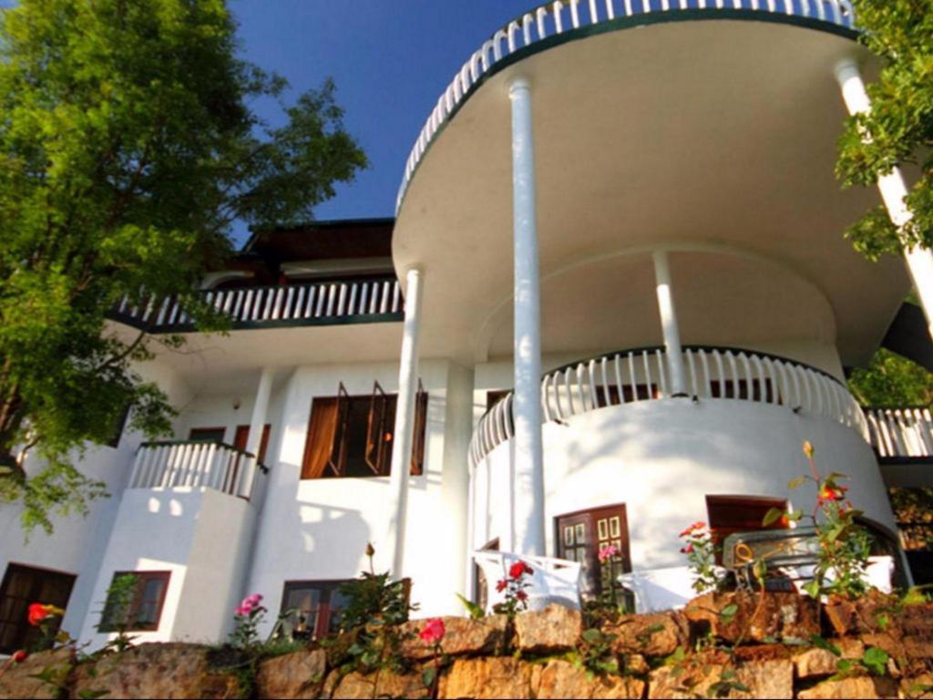 a large white house with a spiral staircase at The Hideaway Hotel in Ella