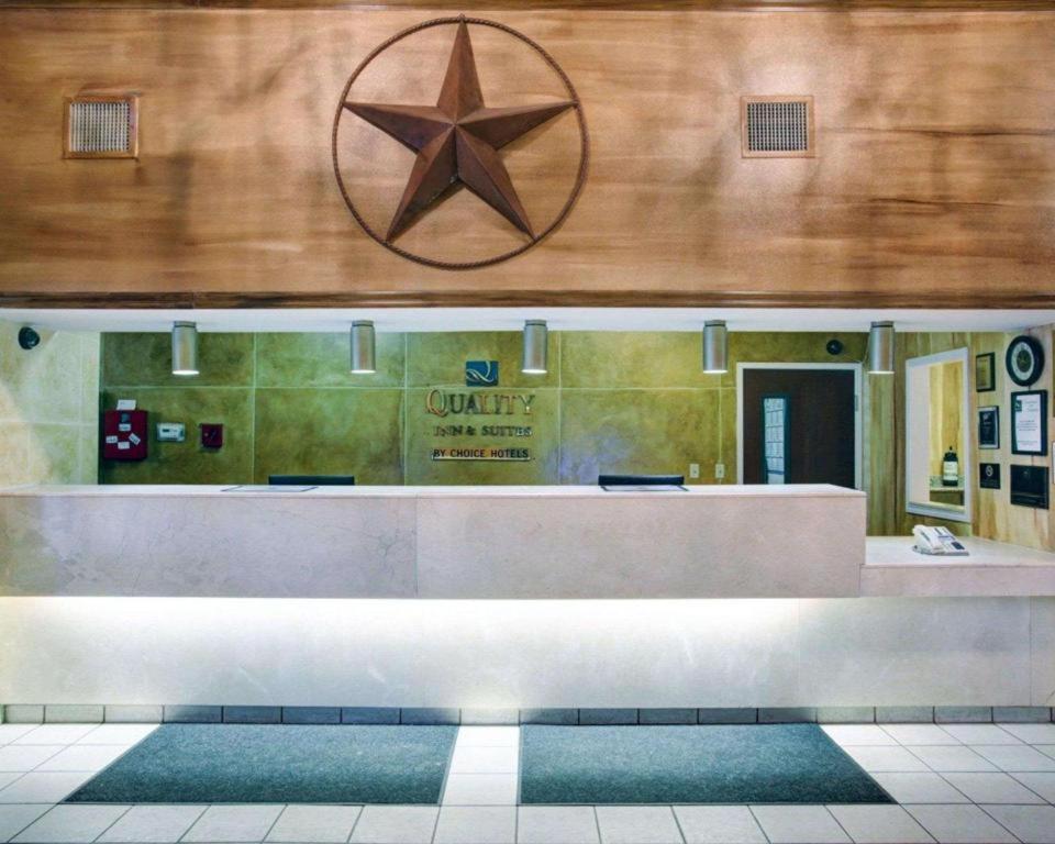 a lobby with a counter with a star on the wall at Quality Inn & Suites Airport in Austin