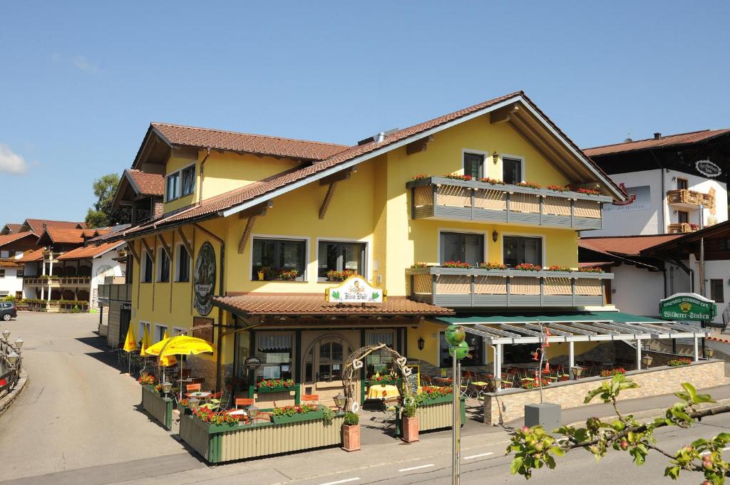 a yellow building on a street in a town at Appart-Hotel Wildererstuben in Bodenmais