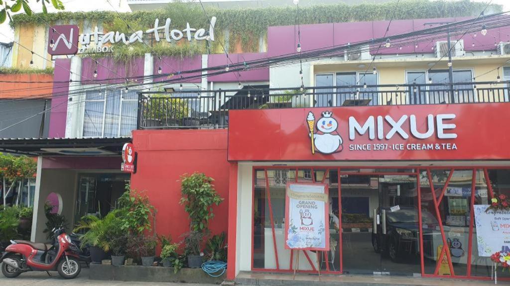 a moped is parked in front of a music store at Nutana Hotel in Gili Trawangan