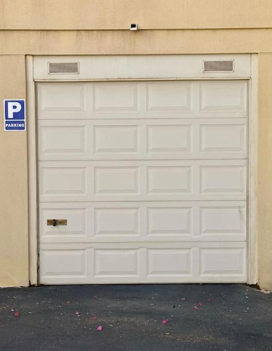 a white garage door on the side of a building at Sol & Mar in El Médano