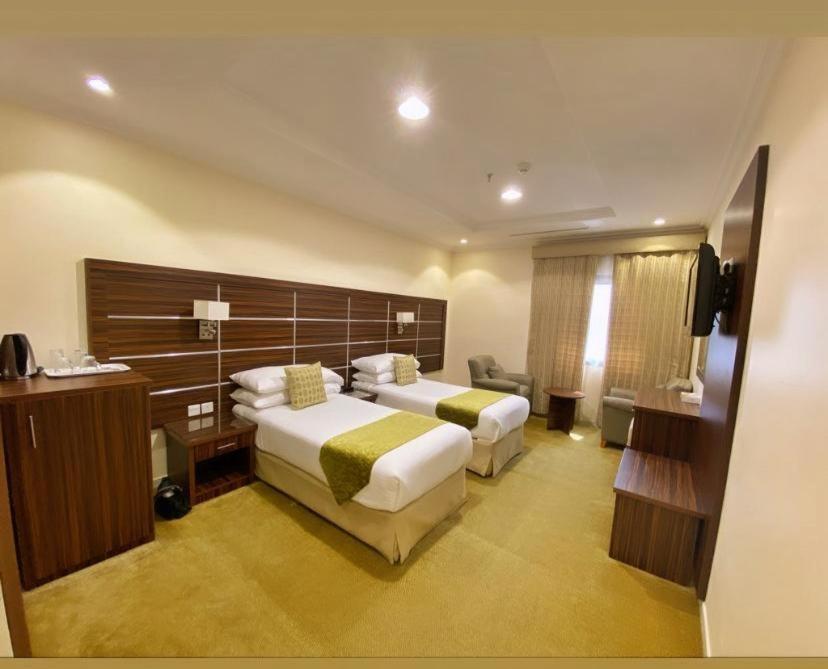 Postel nebo postele na pokoji v ubytování فندق اوتاد المتحدة الماسي awtad elmasi hotel