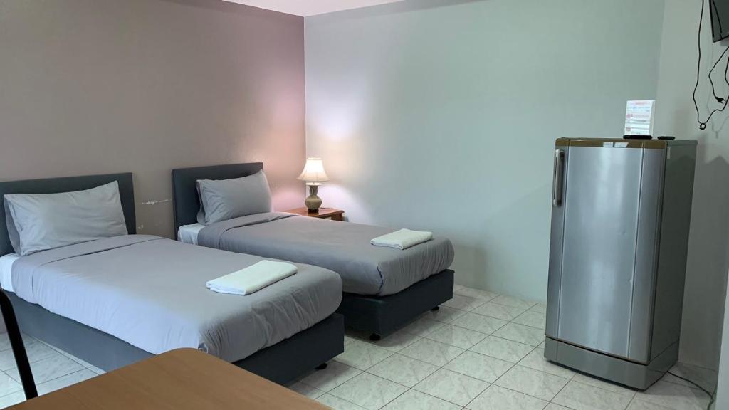 Postel nebo postele na pokoji v ubytování Kamalaburi Guesthouse