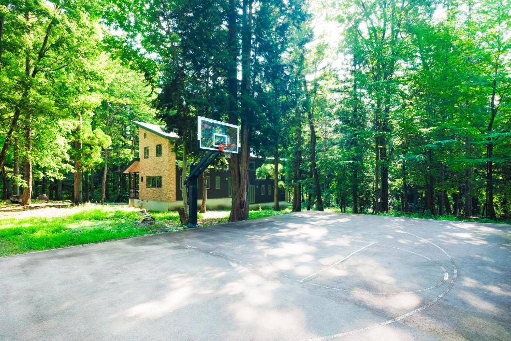 a basketball hoop in the middle of a forest at Phoenix Chalets by HHG in Hakuba