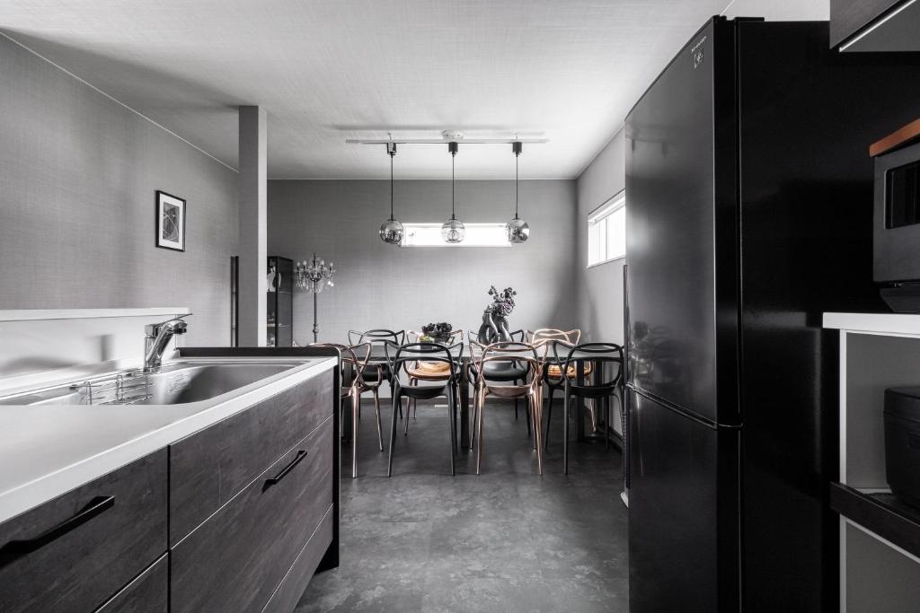 a kitchen with a dining room with a table at The Serenity in Obihiro