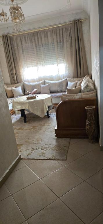 Una sala de estar con un sofá y una ventana. en Dar Simo, en Agadir
