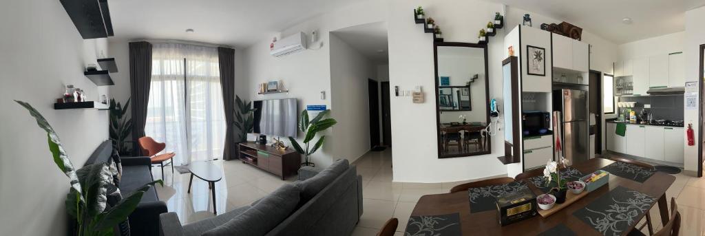 a living room with a couch and a table at Desaru Dhancell Executive Homestay Netflix,8Pax,Wifi in Desaru