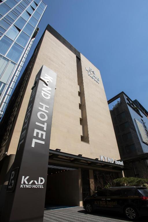 a building with a sign in front of it at Pangyo Business & Tourist Hotel KYND in Seongnam