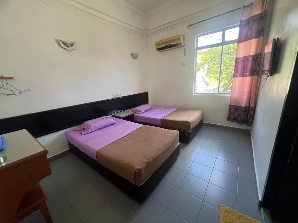 Postel nebo postele na pokoji v ubytování Dung Fang Hotel