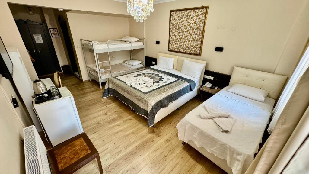 a small room with two beds and a table at EPHESUS CENTRUM in Selcuk