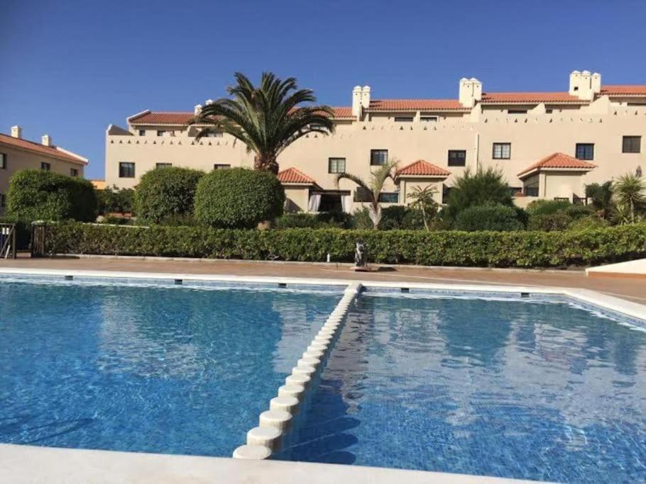 a large swimming pool in front of a building at Pool House Mencey in El Médano