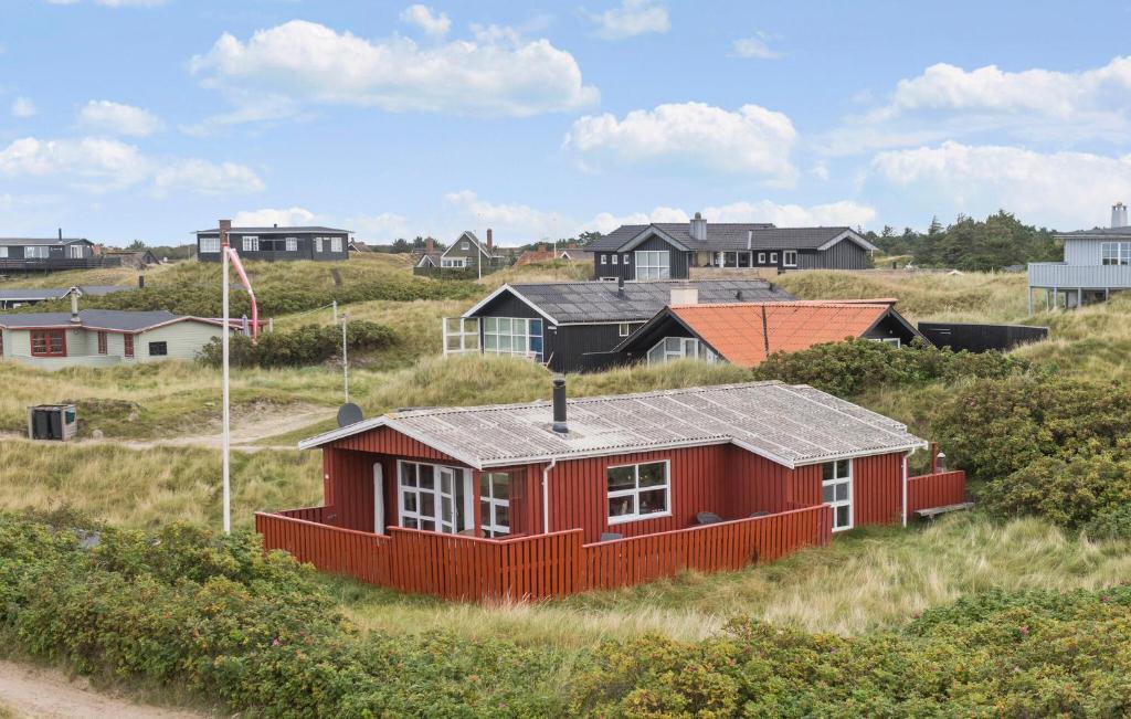 a red house in the middle of a field at Holiday Home Fanø 59 in Fanø