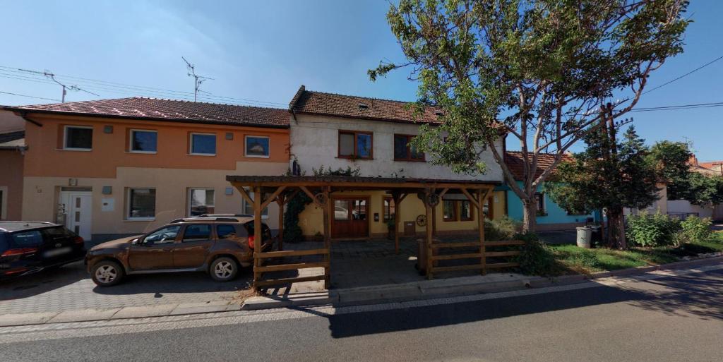 a house with a car parked in front of it at Apartman Romana in Poštorná