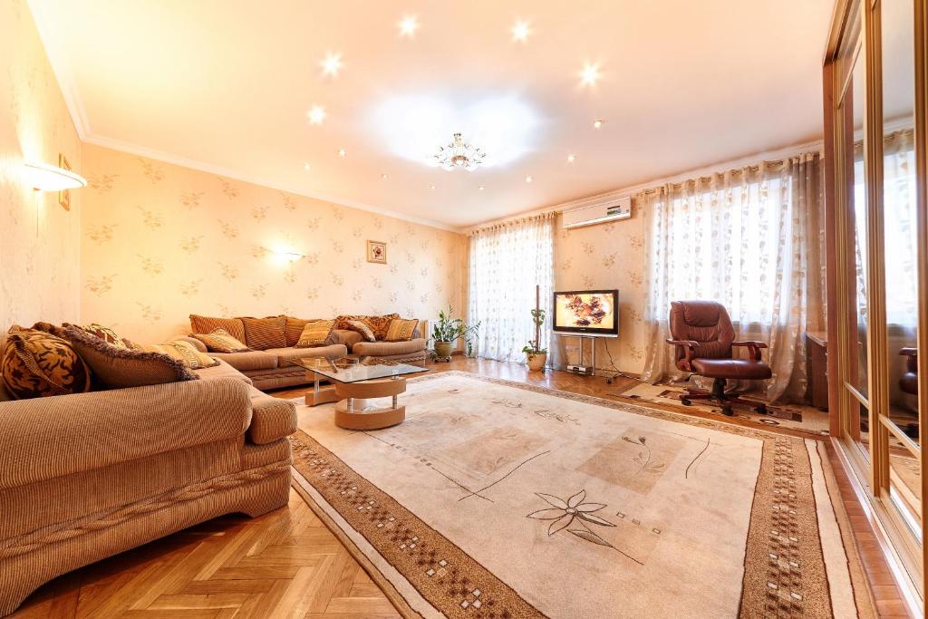 a living room with a couch and a table at Chisinau Centre Apartments in Chişinău