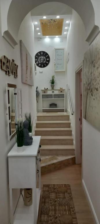 a hallway with stairs and a clock on the wall at My FAMILY INTERO APPARTAMENTO CON PARCHEGGIO PRIVATO in Potenza