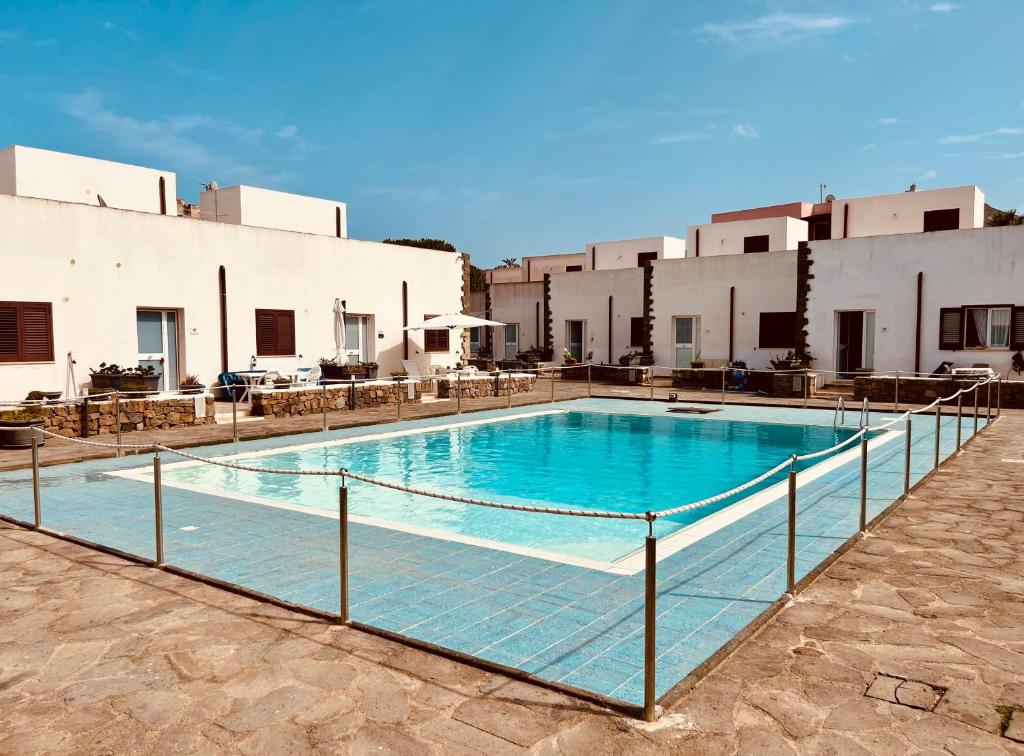 a swimming pool in front of a building at Licinio's Apartments - Casa Lavanda in Pantelleria