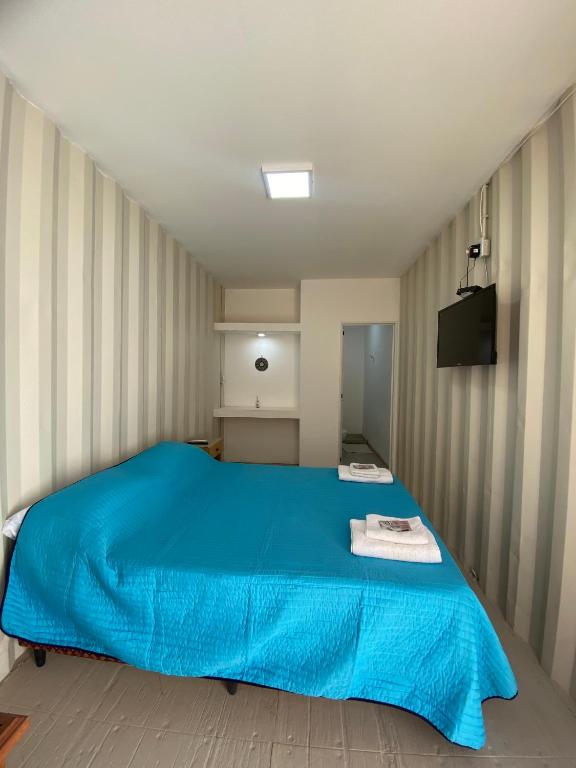 a bedroom with a blue bed in a room at Hotel en Ruta in Fiambalá