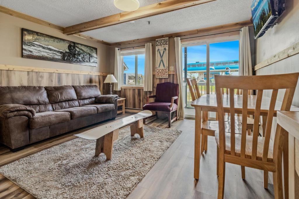 a living room with a couch and a table at ML132 Rustic Mountain Views Wi-Fi EZ Parking 1st Floor in Snowshoe