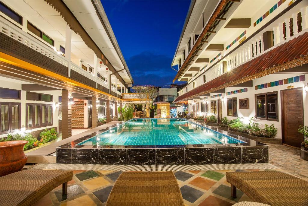 an indoor swimming pool in a building with a hotel at Somwang Boutique Hotel in Chiang Mai