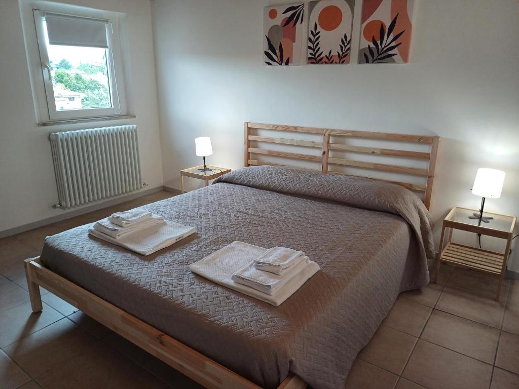 a bedroom with a bed with two towels on it at Fuori dalle Mura Jesi in Iesi