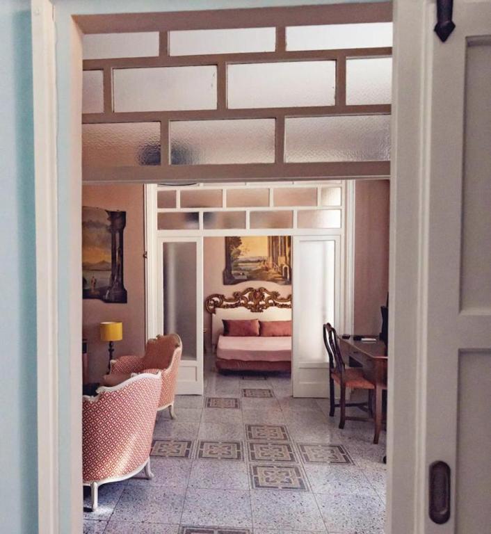 a room with a bedroom with a bed and a table at Luxury Suite Vitruvio 55 in Formia