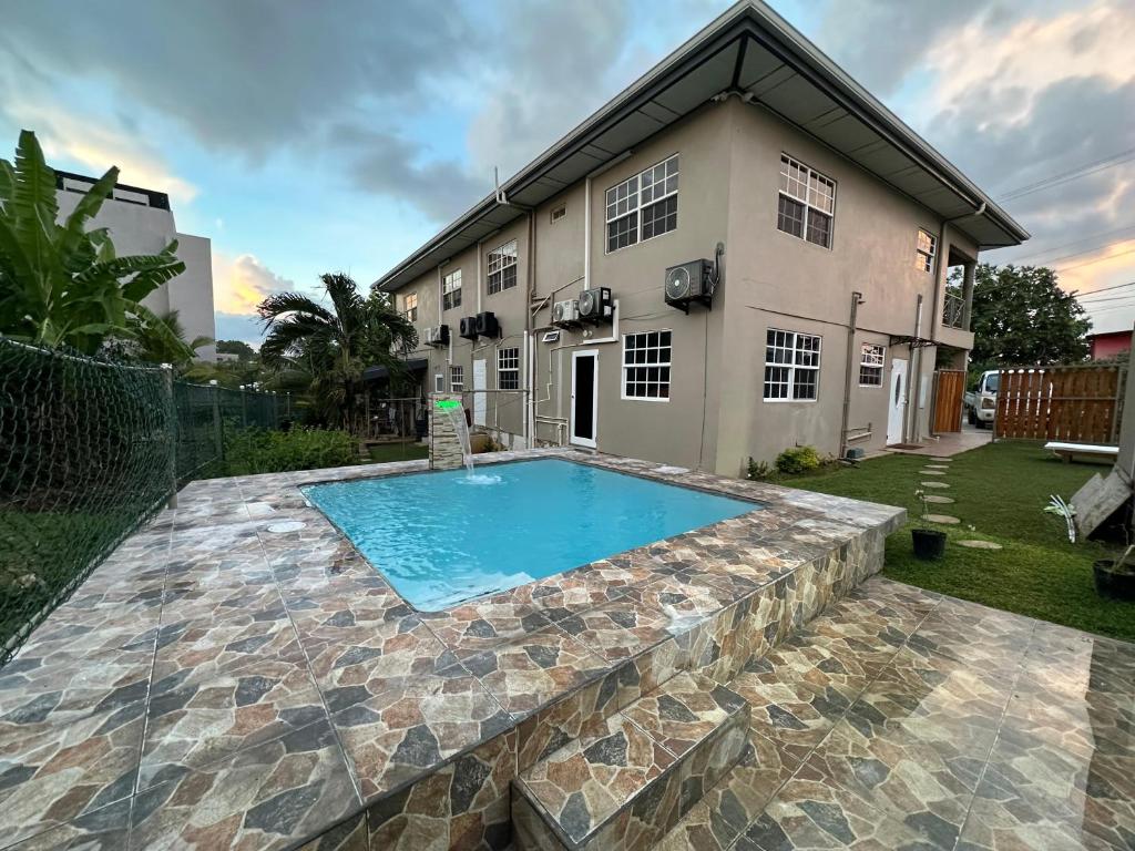 a swimming pool in front of a house at Cozy one bedroom apartment pool side in Lambeau