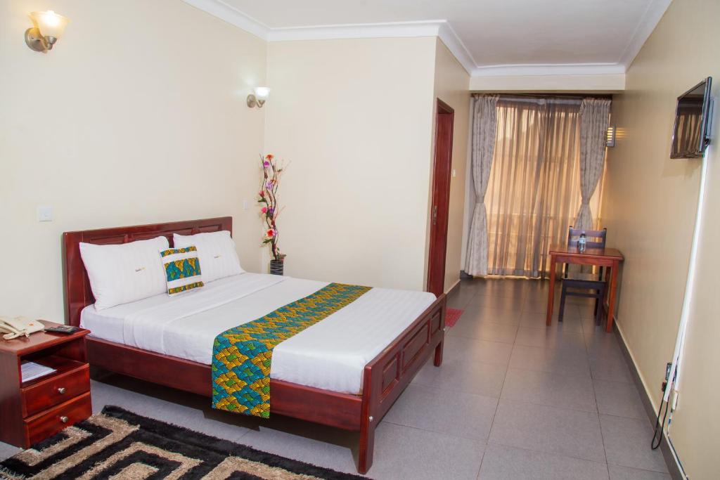 Postel nebo postele na pokoji v ubytování Kenendia Hotel