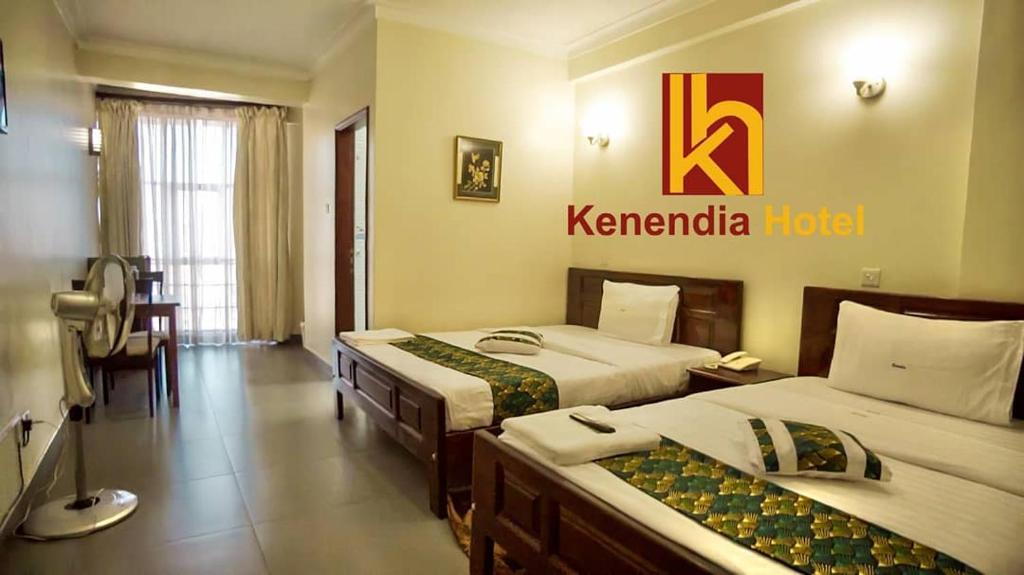 Postel nebo postele na pokoji v ubytování Kenendia Hotel