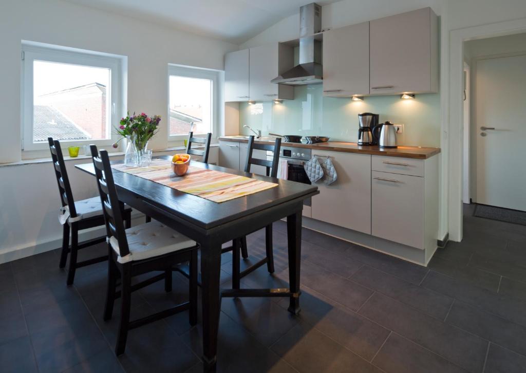 eine Küche mit einem Tisch und Stühlen im Zimmer in der Unterkunft Ferienwohnung im Stadtzentrum in Münster