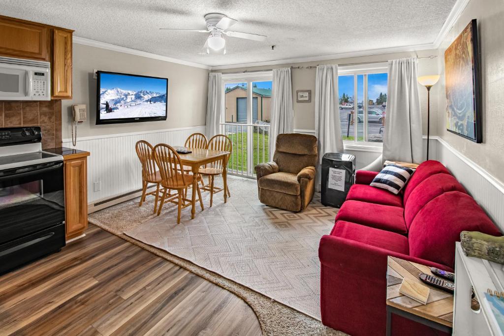 a living room with a red couch and a table at ML147 Fresh And Fun 1BR Sleeps 4 Near Village And Slopes in Dunmore