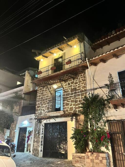 a stone building with a balcony on the side of it at Rosita in Taxco de Alarcón
