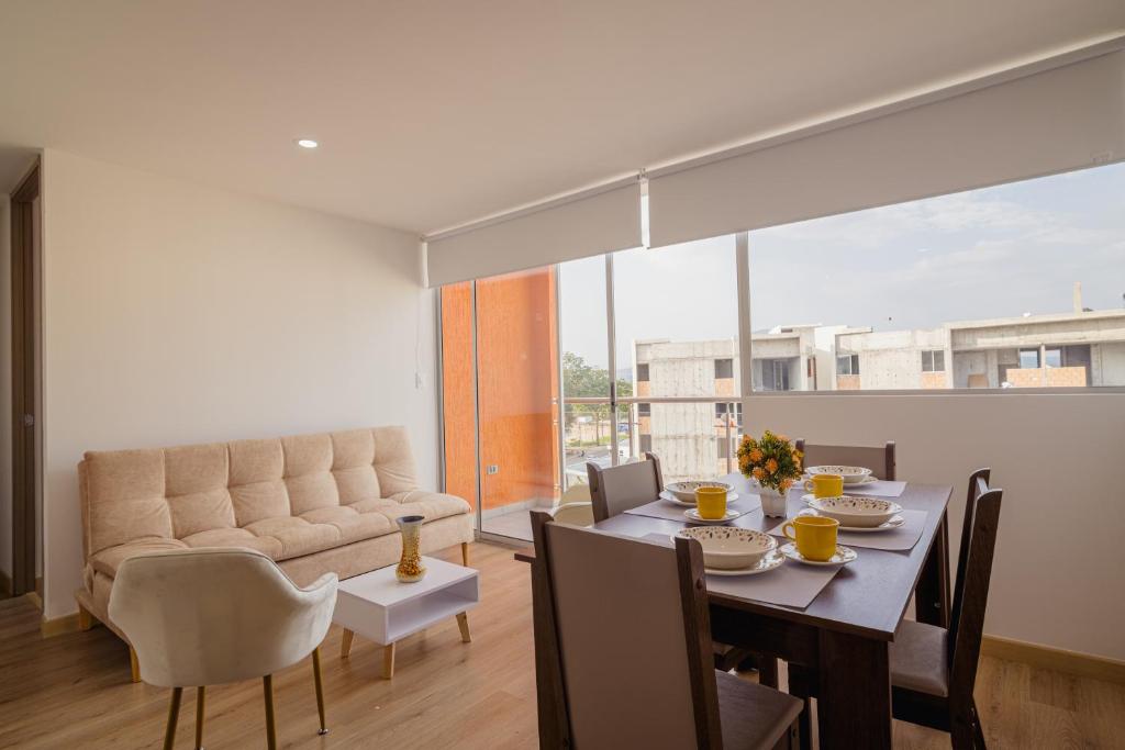 a dining room with a table and a couch at Penthouse en Pitalito in Pitalito