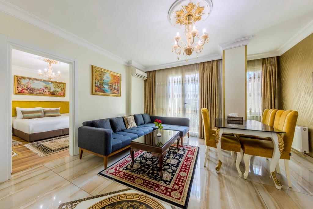 a living room with a blue couch and a table at Lemis Suite Istanbul in Istanbul