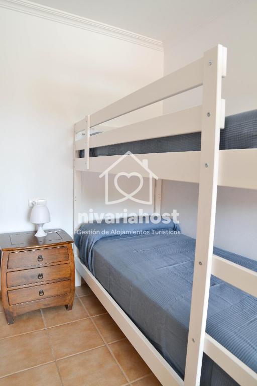 a bedroom with a bunk bed and a dresser at Sunset View La Tejita, by Nivariahost in Granadilla de Abona