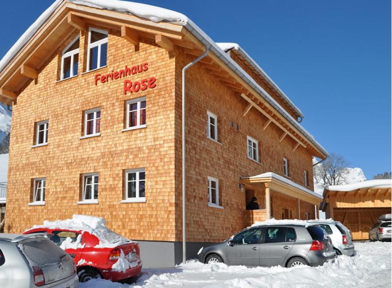 a building with cars parked in front of it at Haus Rose in Schröcken