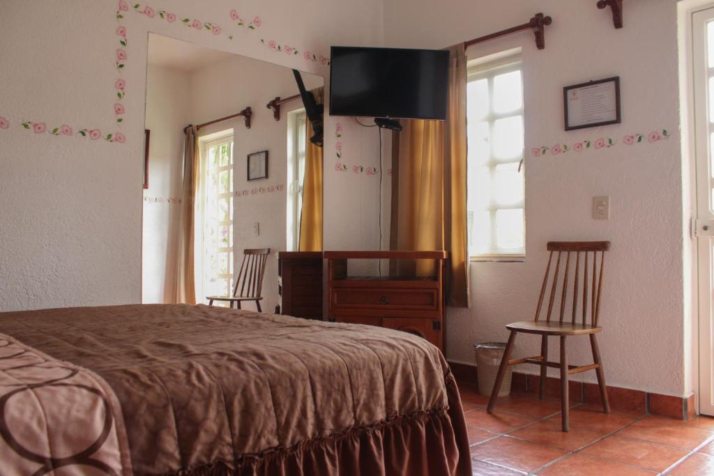 Postel nebo postele na pokoji v ubytování Posada Guayacán Tepoztlán