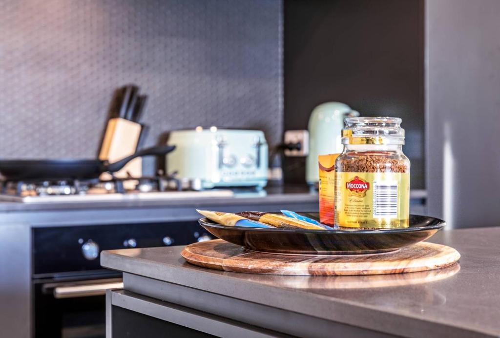 a jar of honey on a counter in a kitchen at Modern APT in Toowong with Mountain View in Brisbane