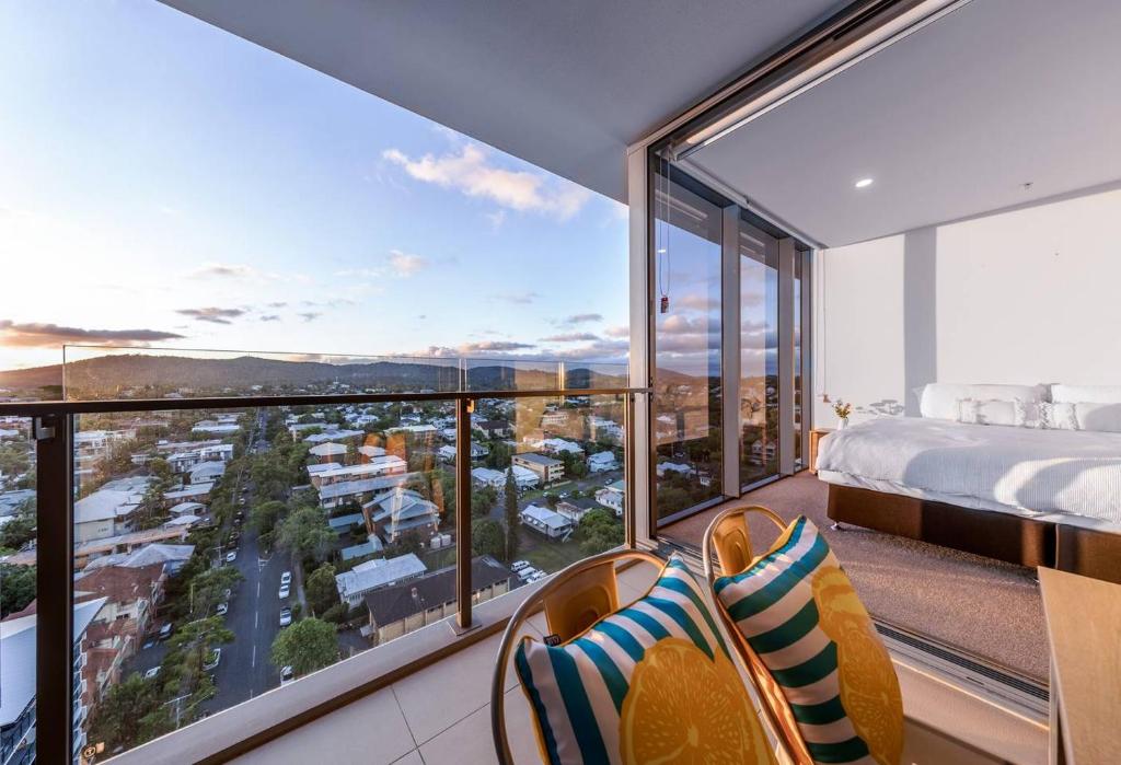 a bedroom with a bed and a view of a city at Modern APT in Toowong with Mountain View in Brisbane