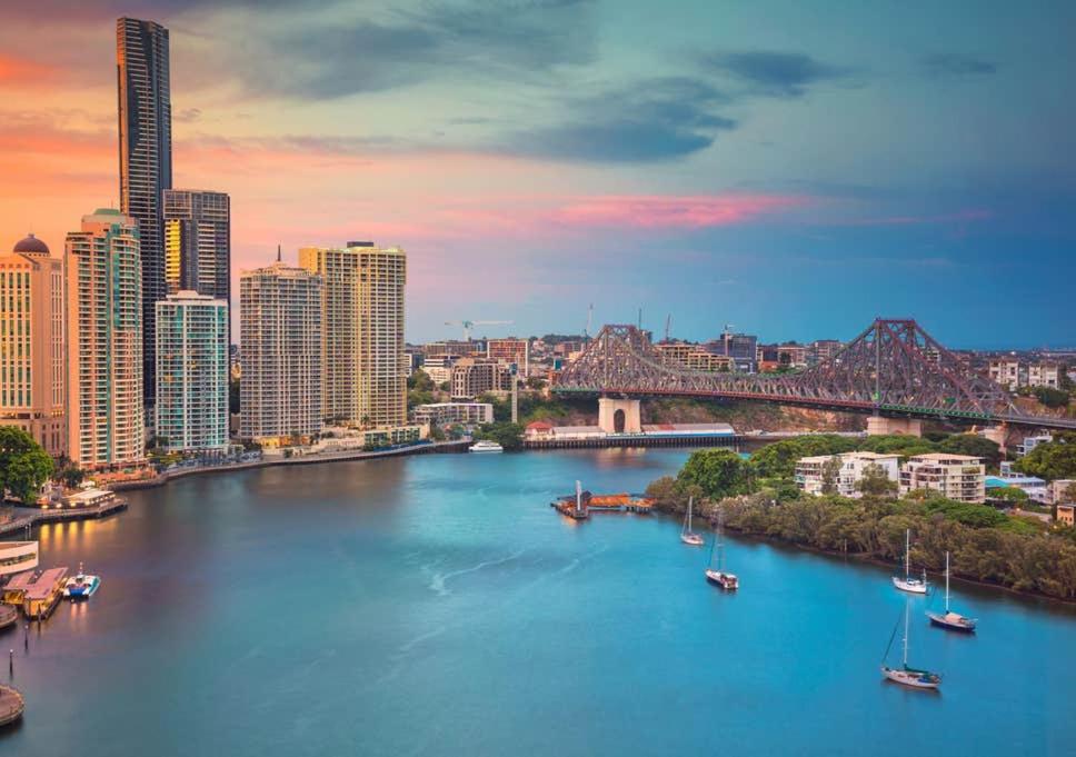 a view of a river with boats in a city at Modern APT in Toowong with Mountain View in Brisbane