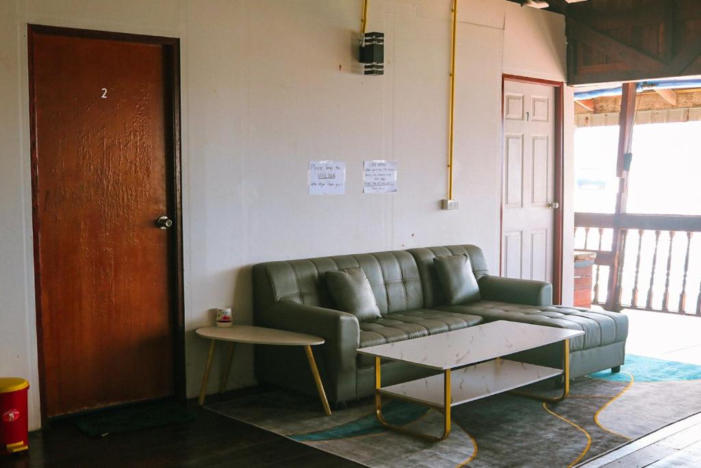 a living room with a couch and a table at WaterMellow Hostel in Koh Tao