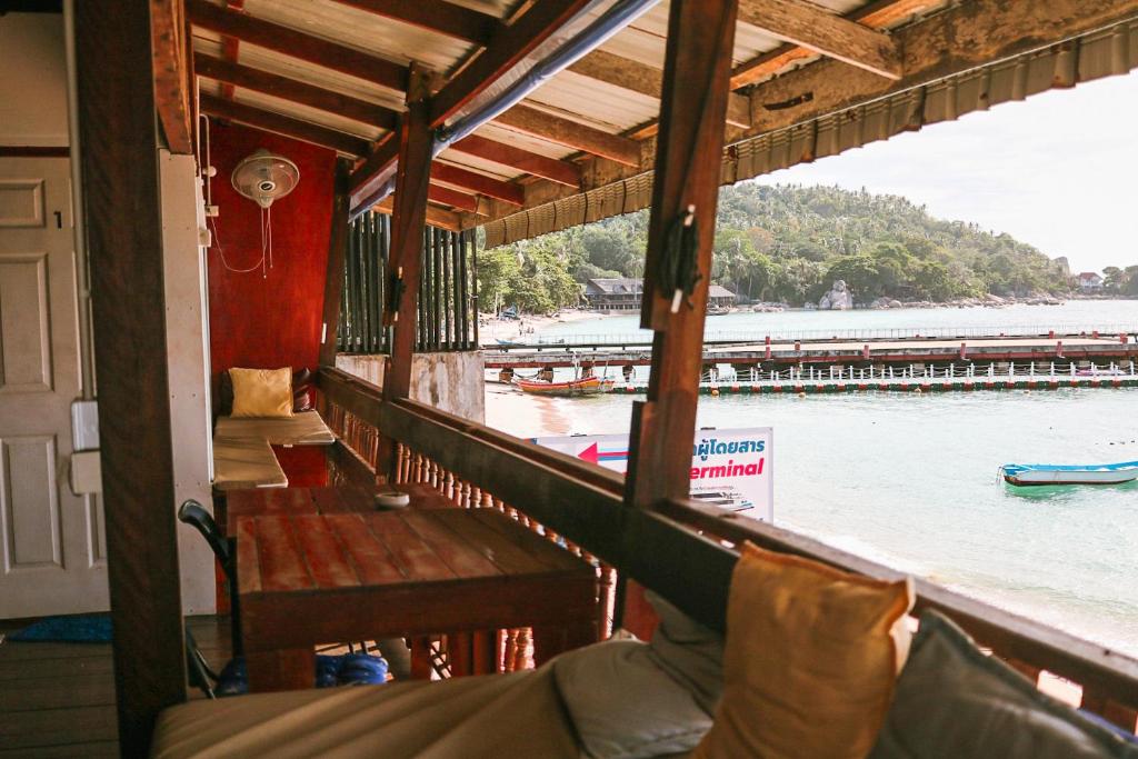 a porch of a house with a view of the water at WaterMellow Hostel in Koh Tao