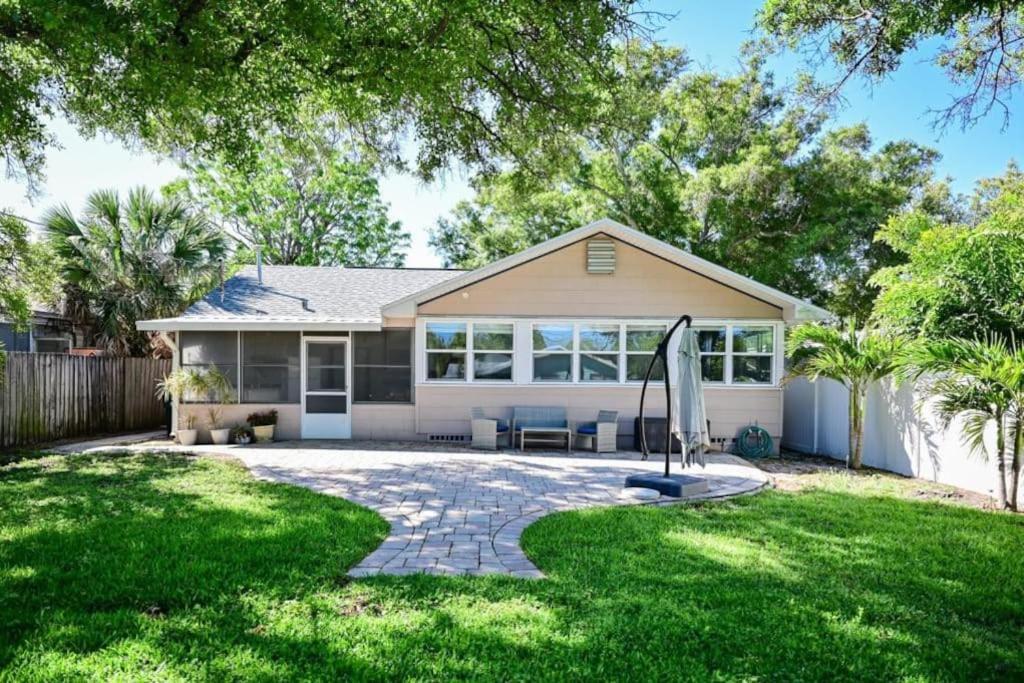 a house with a patio and a lawn at Charming Florida cottage in Largo