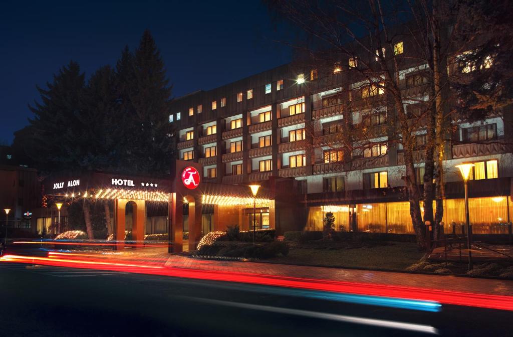 a building on a street at night with at Jolly Alon Hotel in Chişinău