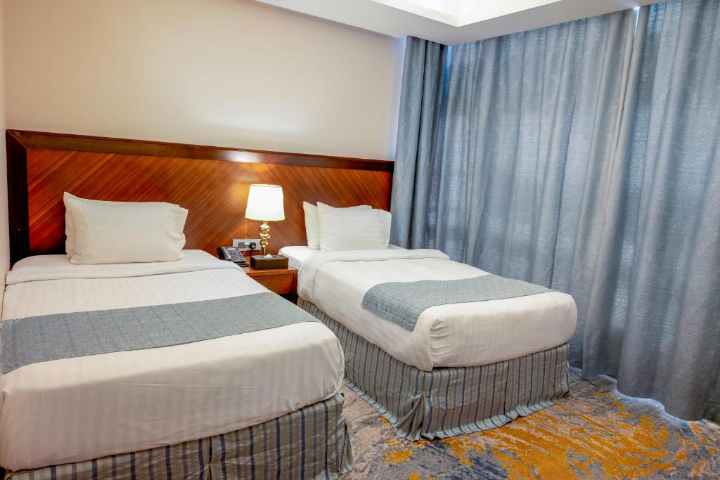 Postel nebo postele na pokoji v ubytování Ruve Jeddah Hotel