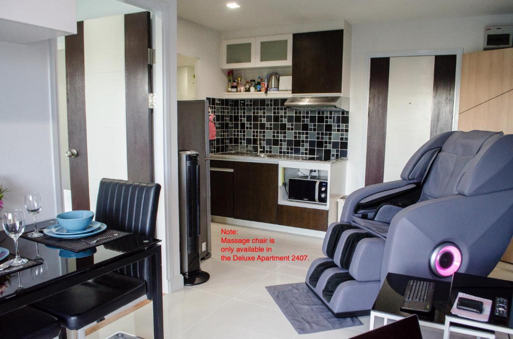 a living room with two chairs and a table at Blue and green Farang homes in Chiang Mai
