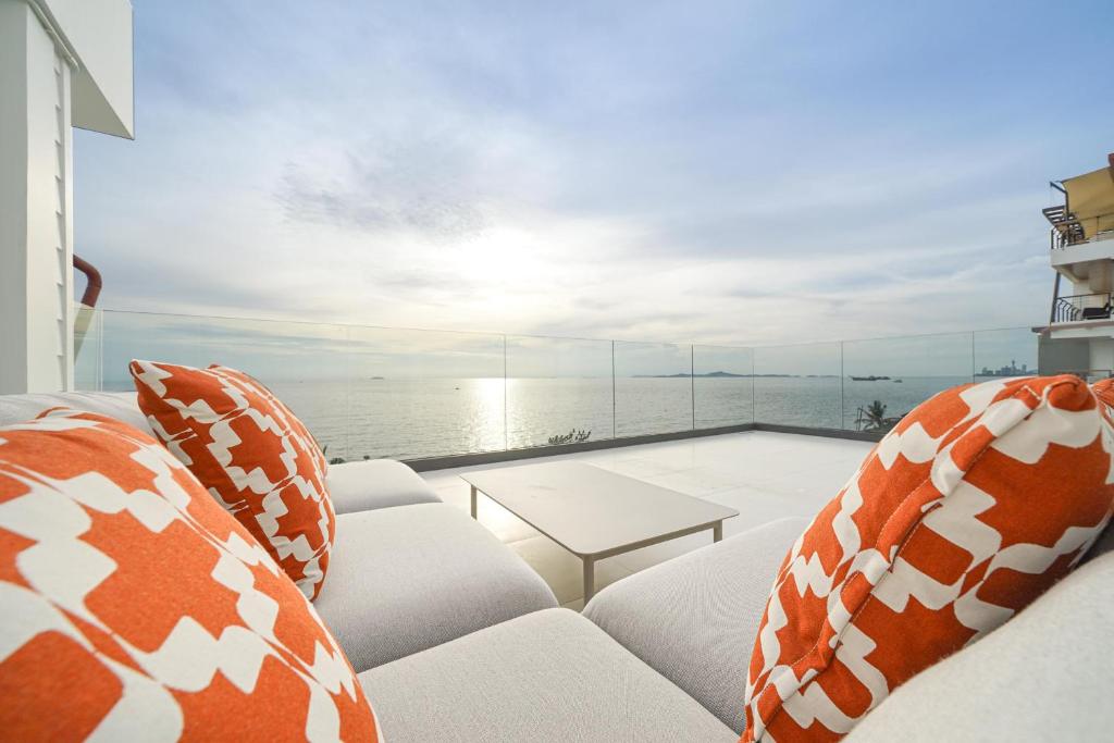 a living room with a view of the ocean at Surf Beach House Pool Villa in Na Jomtien