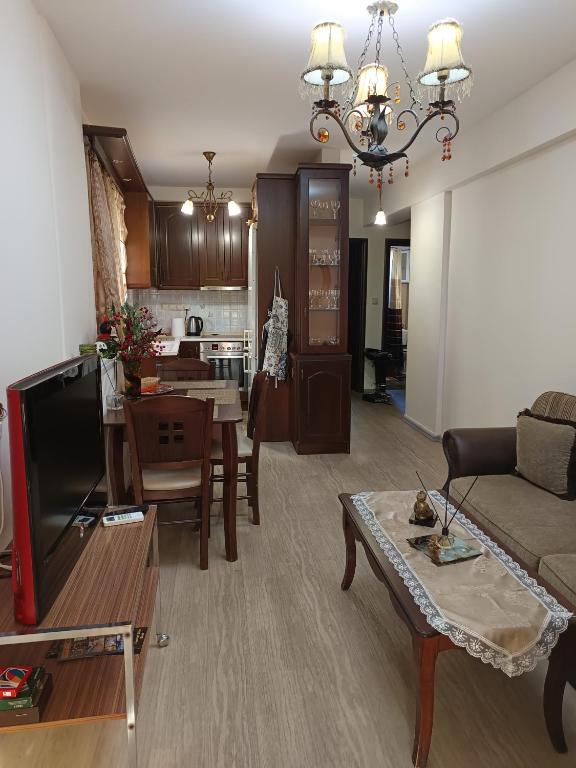 a living room with a couch and a table at Sweet Home Lina in Paralia Katerinis