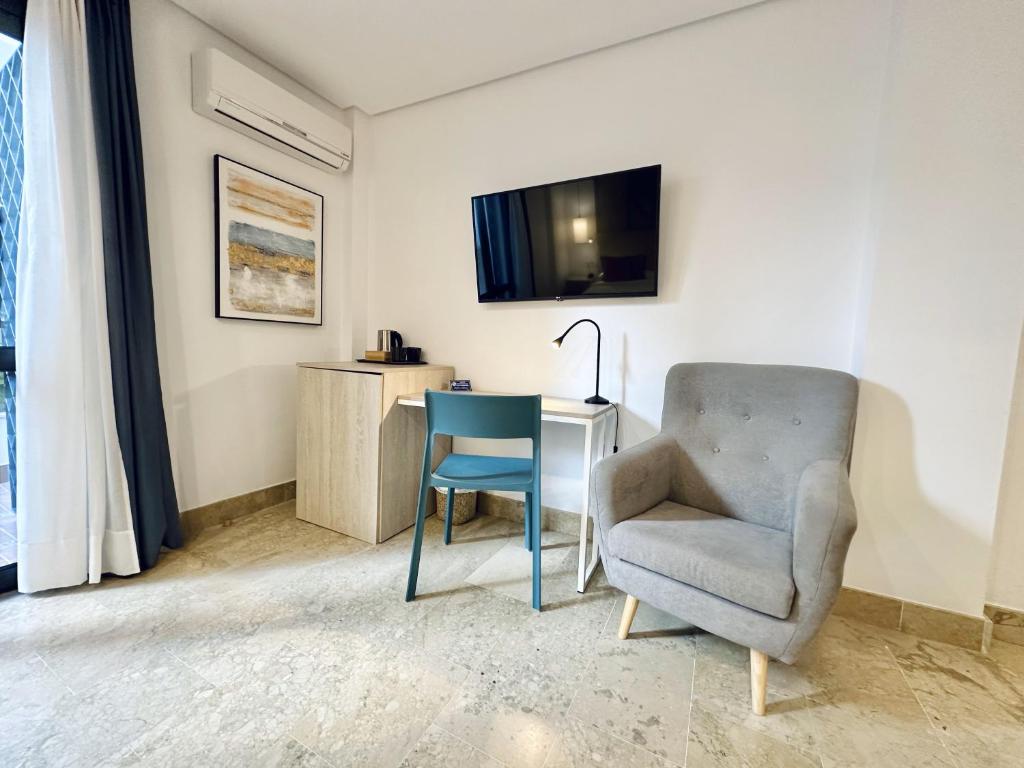 Televízia a/alebo spoločenská miestnosť v ubytovaní Hotel Apartamentos Marina Luz