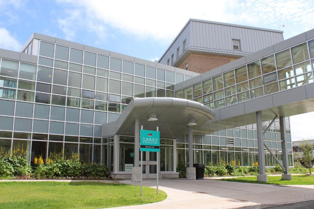 um edifício de escritórios com um sinal em frente em Memorial University em St. John's